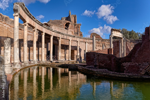  Ancient Roman columns of the Maritime Theater mirroring in water at Villa Adriana in Tivoli Italy