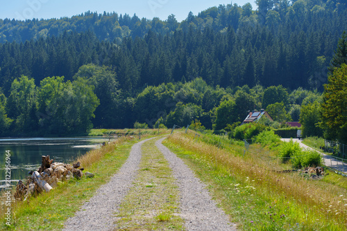 Obraz na płótnie Scenic Dirt Road Along Calm Lake in the Bavaria Forest Landscape
