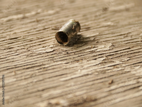 Photography Empty ammo casing on a wooden table