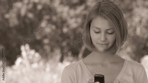 smiling beautiful young woman with phone