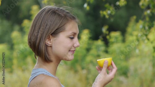 beautiful young woman holding lemon