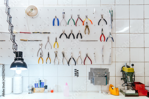 Optical workshop tool wall with pliers and drill press