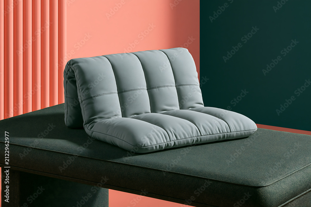 Obraz premium A quilted gray cushion resting on a dark green upholstered bench against a two-tone wall backdrop