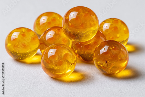 Yellow glass marbles placed on a plain surface in a close-up view