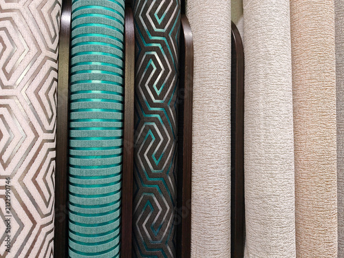 A neat row of wallpaper rolls in different textures and finishes, ideal for anyone looking to redecorate their walls with style
