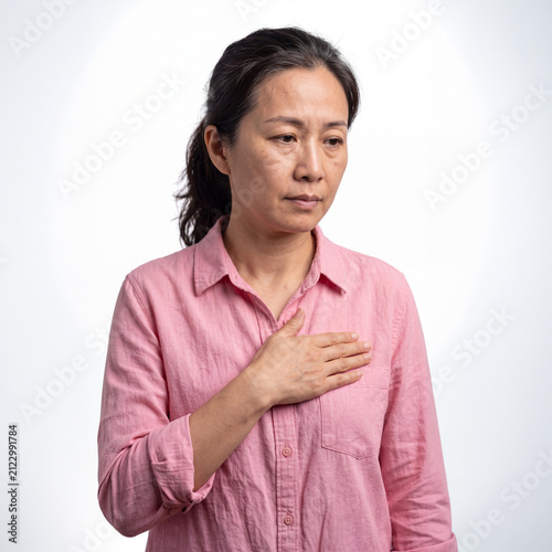 A Woman with Hand on Heart: A pensive middle-aged woman places her hand over her heart, her expression conveying a mix of contemplation and deep emotion.
