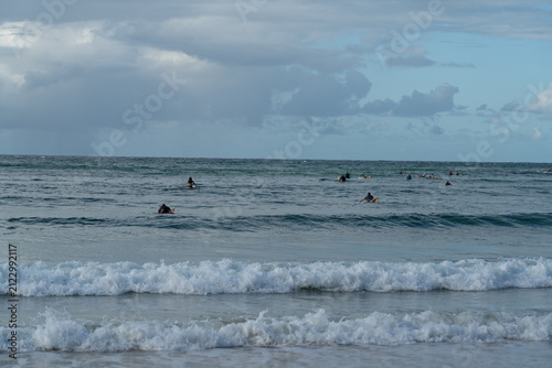 Fotografie Surfers wait for a swell under grey clouds