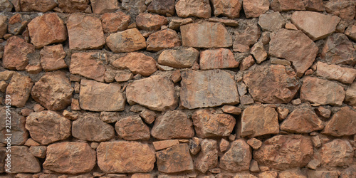 Bild auf Leinwand Rustic stone wall texture, ancient rock masonry, brown stone facade
