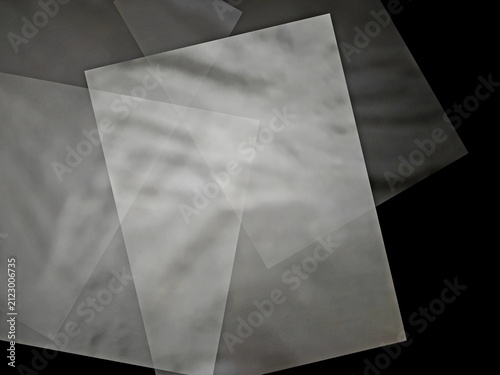 Thin sheet of white of hite paper on a black background.