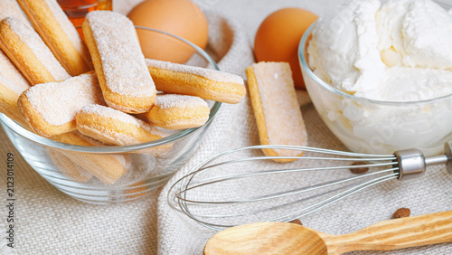 Cooking tiramisu concept, ingredients for making Italian dessert on gray napkin background. Selective focus