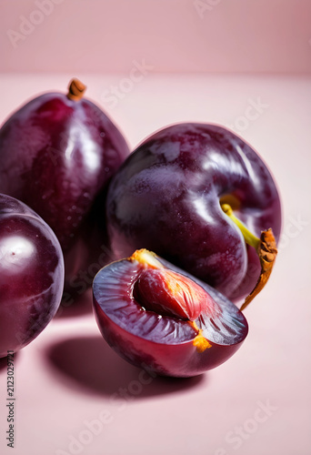 Fresh purple plums with one...