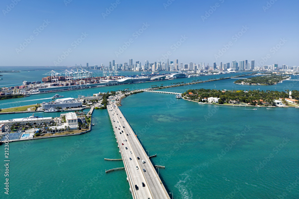 Obraz premium Miami skyline in aerial view. Miami skyline on Biscayne Bay. Miami skyline with bridge and harbor. Miami skyline for urban travel.