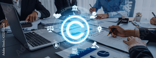 Quadro su tela A dynamic business meeting scene showcasing professionals engaged in discussion around a table, with a digital copyright symbol highlighting the importance of legal innovation