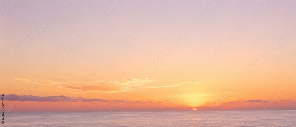 Fototapeta premium Beautiful Sunset Over Calm Ocean Horizon with Vibrant Orange and Pink Hues.