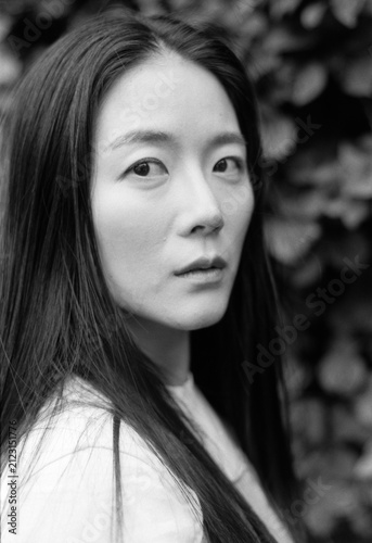 Bild auf Leinwand Young asian woman gazing with melancholic expression