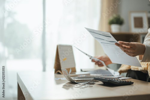 bill review, financial paperwork, and calculator shape this practical household finance scene. It conveys practical choices, organized planning, everyday money management, and financial awareness.
