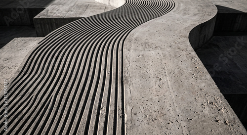 Abstract concrete background with grooved wavy pattern and strong shadows.