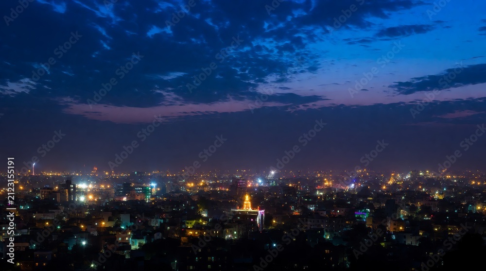 Fototapeta premium Majestic city skyline glowing under evening twilight with illuminated structures