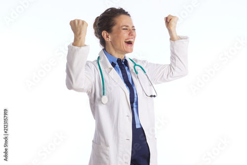 Obraz na plátne A happy female medical professional in a lab coat and tie raises her fists in a celebratory gesture, expressing triumph and success in her clinical work