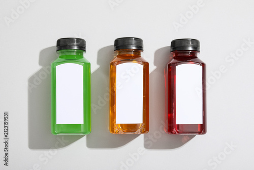 Three colorful juice bottle...