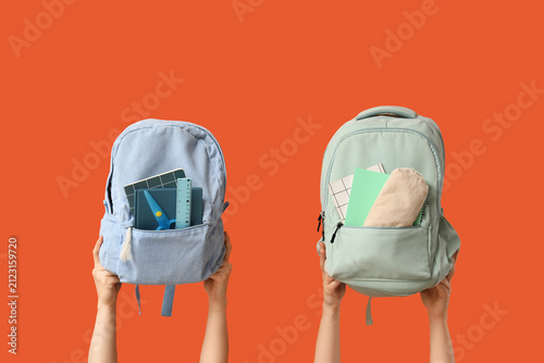 Two hands holding up school...