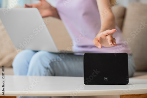 Woman reaching for a black ...