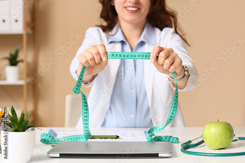 Female nutritionist holding...