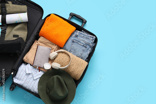 Open black suitcase packed ...