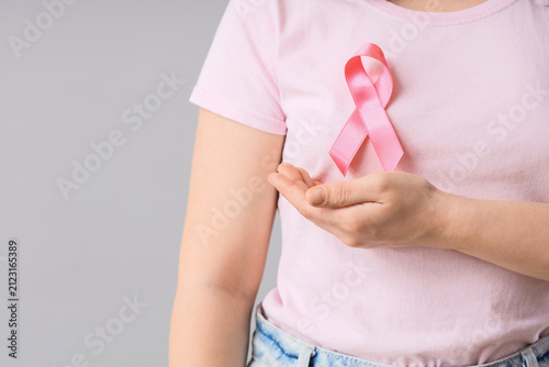 Young woman with pink ribbo...