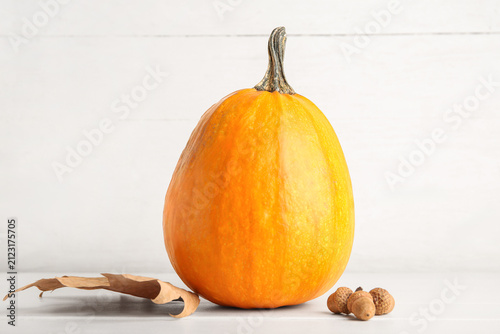 Raw pumpkin, dry leaf and a...