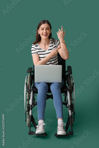 Young woman with laptop poi...
