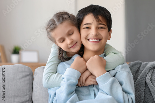 Little girl hugging her bro...