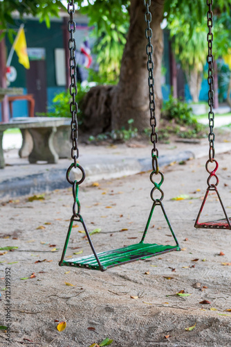 Educational Parenting. Empty Metal Chain Swing in Playground