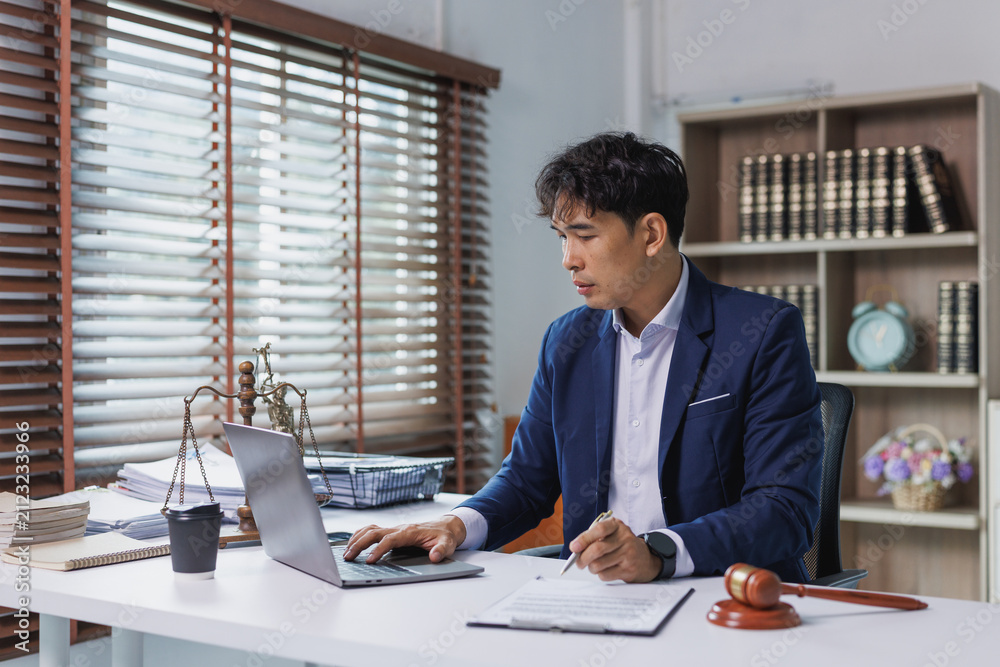 Obraz premium Lawyer working at desk with scales of justice and gavel