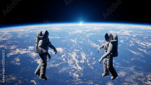 Bild auf Leinwand Astronauts Floating in Zero Gravity Above Planet Earth Horizon Mission with Bright Sun Flare Over Earth Atmosphere