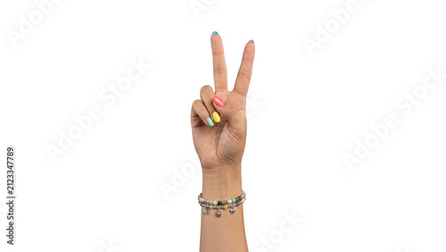 Woman’s hand showing a peace sign with bright multicolor nails and layered charm bracelets, isolated on a transparent background