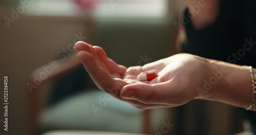 Healthcare, pills and hands with antibiotics in home, prescription or medical medicine for recovery. Wellness, treatment and person with tablets, pharmaceutical drugs and healing with supplements