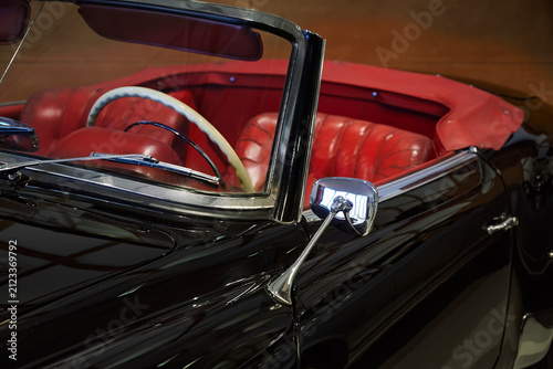 Obraz na plátne A classic 1950s roadster, featuring a distinctive chrome side mirror and white steering wheel