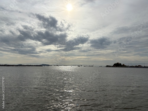 Dramatic cloudy seascape with sunlight reflection in Si Racha, Thailand