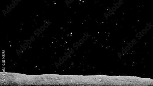 Snow falls on a wooden floor with a pile of snow