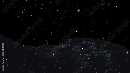 Snow is falling against the backdrop of mountains and a black background