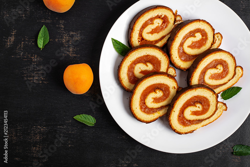 Traditional Swiss Roll with Apricot Filling and Fresh Apricots. Top view