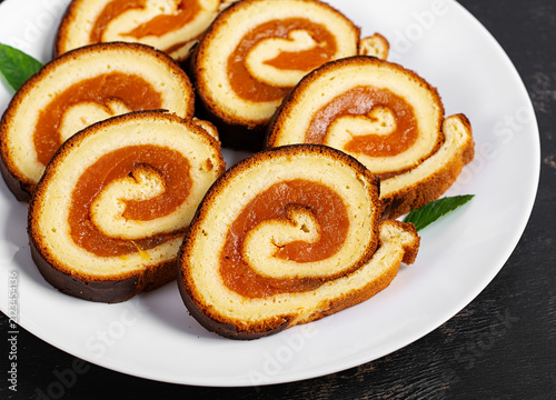 Sweet Apricot Swiss Roll Dessert on Dark Background