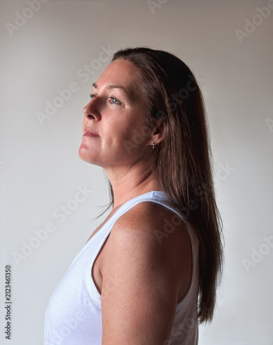 Mature woman in profile looking up hopefully