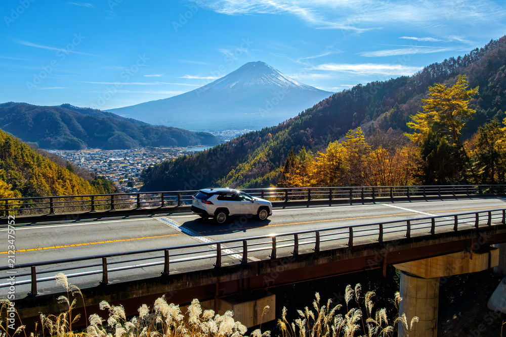 Fototapeta premium Mount Fuji with blurred cars driving on the road in Autumn, Japan.
