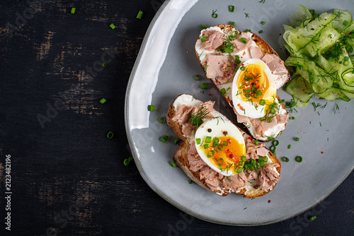 Gourmet Tuna Toasts with Soft Boiled Eggs on Artisan Bread. Top view