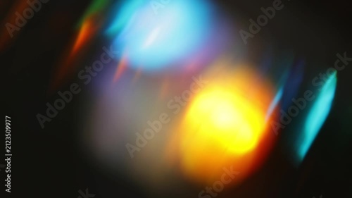 Diagonal colorful bokeh streaks with prism light leaks on a black background for digital screens, music visuals and abstract design