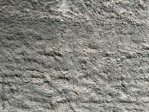 Quadro su tela Close-up of rough grey concrete texture with shadows and highlights