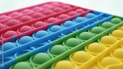 Rainbow Colored Pop It Fidget Toy Sensory Bubble Popping Fun Close Up Overhead Studio Shot
