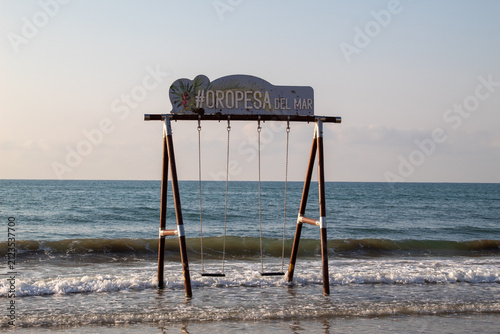 Obraz na plátně Wooden swing in the Mediterranean Sea at La Concha Beach, Oropesa del Mar, Spain